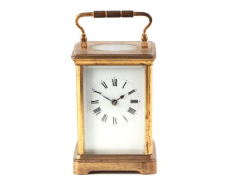 A carriage clock, the white enamel dial with Roman numerals, fitted in a four-pillar brass case, 11cms high.
