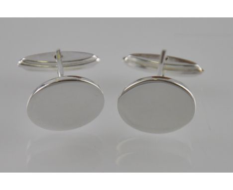 A set of silver plain oval cufflinks with a bar and swivel fitting