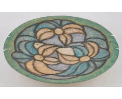 A salt glazed ceramic tripod dish, the bowl with incised green, turquoise, and gilt stylised floral decoration, by Catriona T