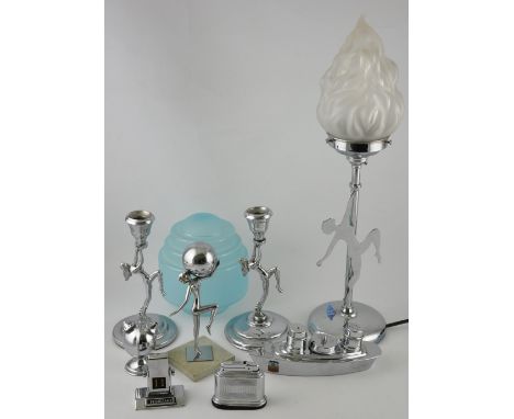 An Art Deco-style chromed table lamp with frosted glass torch shade on circular base, the stem adorned with a dancing female 