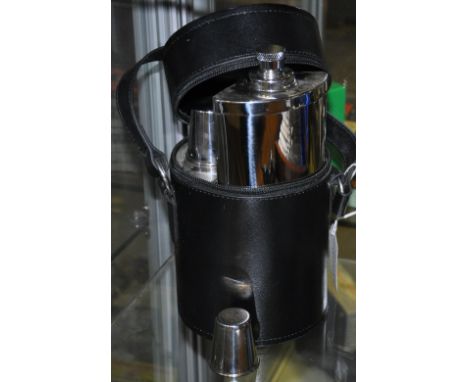 A stainless steel travelling spirit flask and tot set in black faux leather case