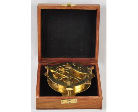 A large brass compass with astronomical instrument in a wooden box