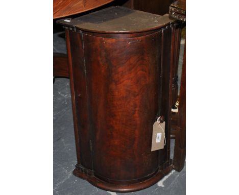 A small Dutch style mahogany bow front hanging corner cupboard together with a mahogany standard lamp