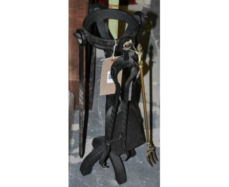 A wrought iron companion set and a brass toasting fork