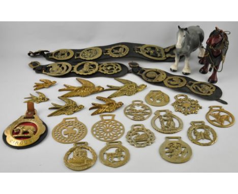 Ten horse brasses on three leather harnesses, together with thirteen further horse brasses, two ceramic shire horse figures, 