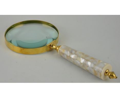 A large table magnifier, brass bound with a mother of pearl handle