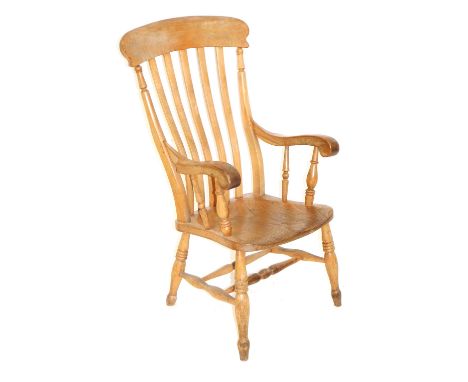 A Victorian beech and elm lath back kitchen chair, with solid saddle seat, raised on turned legs united by a double H framed 