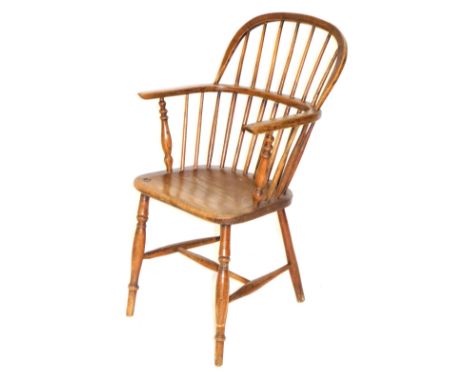 A Georgian oak and elm hoop back Windsor chair, with solid saddle seat, raised on turned legs united an H framed stretcher, 5