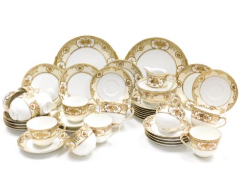 An early 20thC Noritake porcelain tea service, gilt decorated with flowers and foliate scrolls, on a pale yellow ground, comp