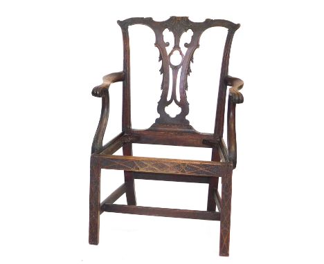 A Georgian Chippendale style mahogany carver chair, with a foliate carved crest rail and vase shaped splat, raised on a frame