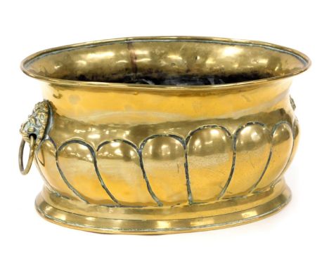 A Victorian brass semi fluted planter, with twin lion's head and ring handles, 29cm wide. 