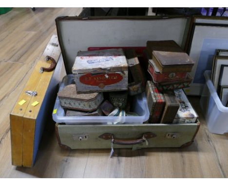 Suitcase containing vintage tins and folding wooden portable table