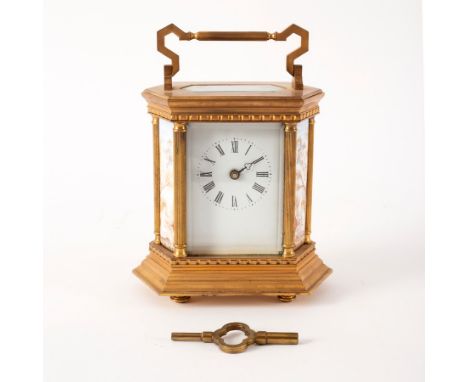 A gilt brass mantle clock set with porcelain panels of cherubs to the sides, 18cm high