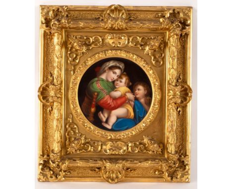 A circular porcelain plaque, La Madonna della Seggiola after Raphael, 18.5cm diameter in a fine Venetian gilt plaster frame w