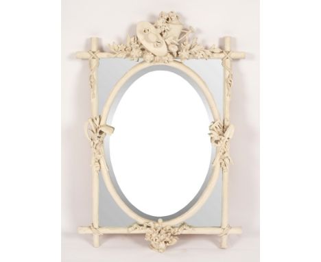 A white painted segmented mirror, the crest decorated a spray of flowers and a watering can, the faux bamboo frame decorated 