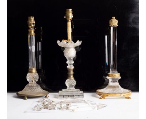 A Regency lustre table light hung nine glass drops, 37cm high and two gilt metal mounted table lights