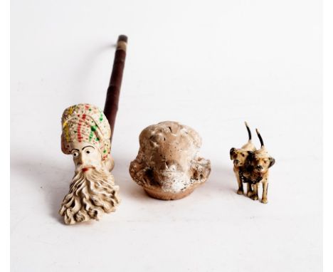 A clay pipe, the bowl inscribed Jacob, a ram's mask head and two metal hounds
