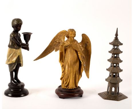 A bronzed metal candlestick figure of a Nubian, 24cm high, a gilt metal figure of a Saint and a gilt brass pagoda