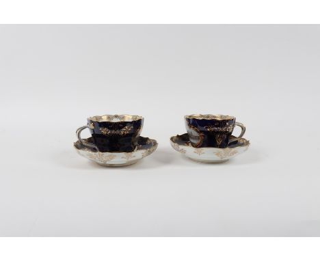 A pair of Meissen teacups and saucers, circa 1860, one cup painted a view of Meissen, the other a view of Dresden, the saucer