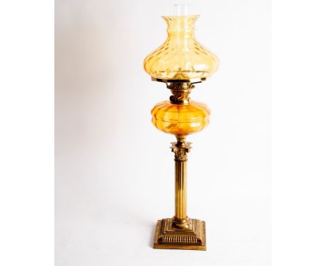 A 19th Century oil lamp with glass shade and well, on a Corinthian column candlestick base, 77cm high CONDITION REPORT: This 
