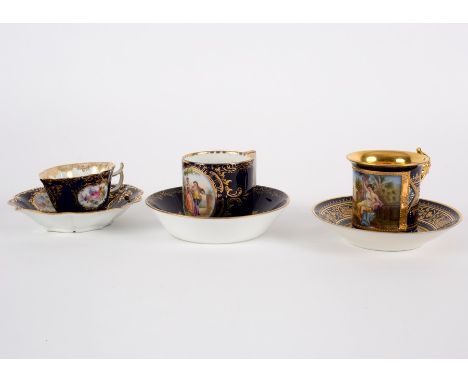 Three late 19th Century Continental porcelain blue ground cabinet cups and saucers, comprising two Vienna style cups and sauc