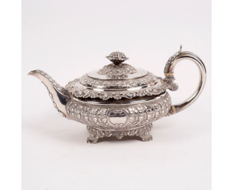 A George IV silver teapot, Emes &amp; Barnard, London 1824, of compressed circular form with cauliflower finial and shell and