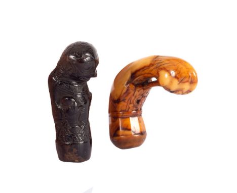 An ebonised kriss handle in the form of a grotesque and a vegetable ivory kriss handle carved stylised designs CONDITION REPO