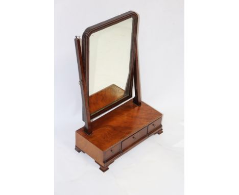 A mahogany swing frame dressing table mirror, the base with striped boxwood stringing and fitted three drawers, on ogee brack