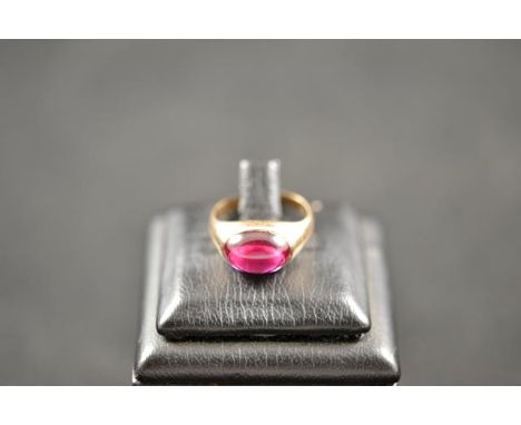 A yellow metal ring set with oval cabochon synthetic ruby - size J 1/2, approx gross weight 4.8g.CONDITION REPORTGood conditi