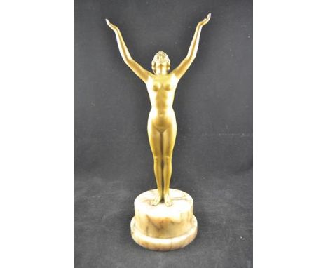 An Art Deco spelter figure of a female nude with arms outstretched, coloured stones to headband, mounted on circular plinth, 