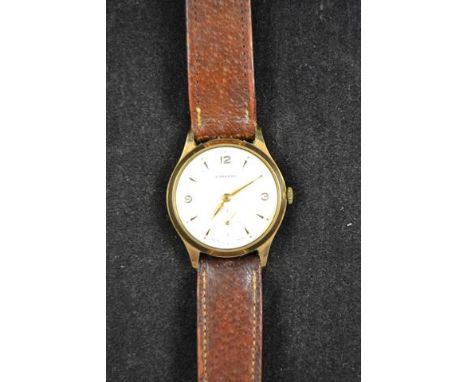 A Garrard gentleman's 9ct gold cased wristwatch, gilt Arabic and baton dial, presentation inscription to reverse, brown leath