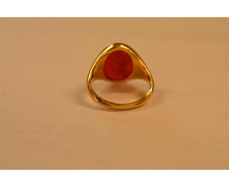 A yellow metal signet ring set with carnelian intaglio carved with Roman style figure - size L 1/2, approx gross weight 6.8g.
