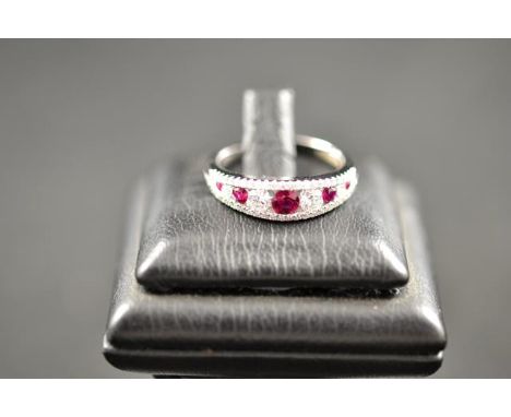 An 18ct gold ruby and diamond half hoop ring, size M.CONDITION REPORTgood condition