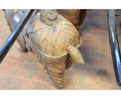 A Black Forest carved hardwood brown bear, painted saddle and face mask to rear - H70cm, L135cmCONDITION REPORTsigns of wear 