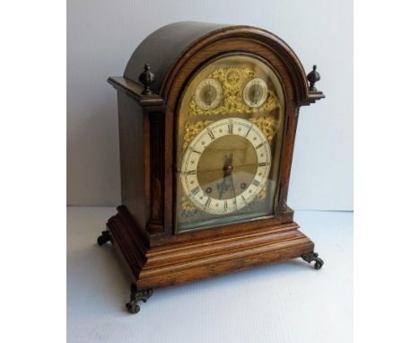 A late Victorian oak and brass dial bracket clock for Morath Bros., Liverpool, the arched dial with three movements, embellis