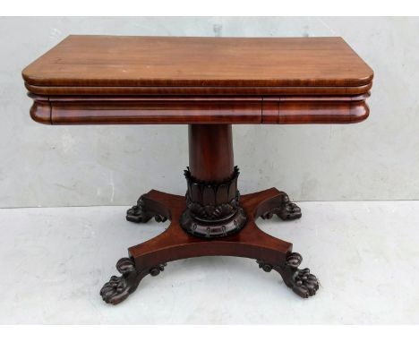 A William IV mahogany fold-over card table with baize top, gun barrel support, finely carved lotus leaf decoration to collar 
