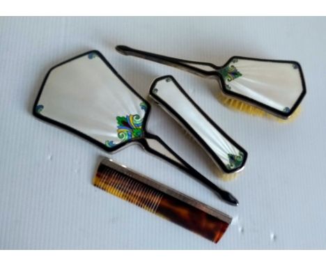 An Art Deco three-piece silver and guilloche cased brush set in ivory-ground with multi coloured enamel floral decoration wit