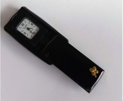 A Van Cleef & Arpels foldaway quartz miniature travel clock with canted rectangular silvered dial, signed, Roman and baton nu