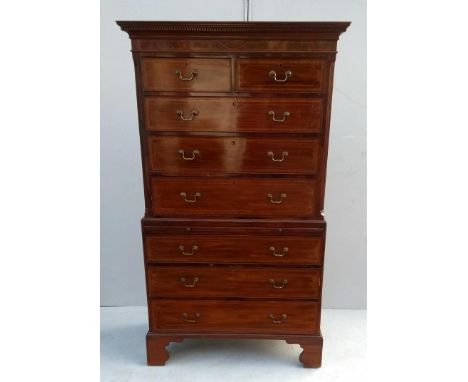 A 19th century mahogany tallboy or chest on chest with dentil cornice, crossbanding and inlay decoration, brushing slide, bra