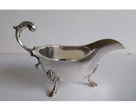 A George V silver sauce boat with wavy rim and three hoof feet by Charles Alfred Alston, London, 1928, 216g 