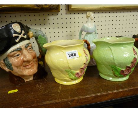 Royal Doulton 'Long John Silver' character jug, two Carltonware Green Leaf type jugs and a Coalport figurine