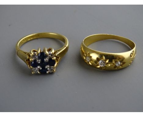 Two eighteen carat gold diamond set rings, one with central blue stone cross, size 'K', the other with three tiny diamonds in