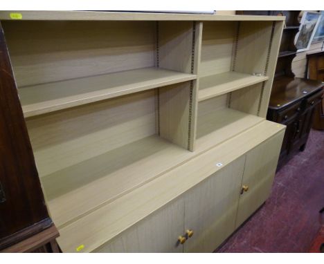Modern light wood bookshelf with three base cupboards
