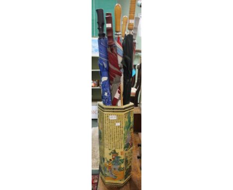 A Chinese porcelain stick stand containing seven umbrellas