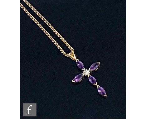 A 9ct hallmarked amethyst and diamond cross comprising five marquise cut claw set amethysts and a central diamond, length 3cm
