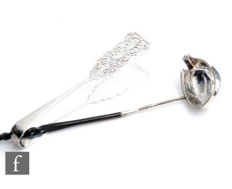 A pair of hallmarked silver asparagus servers with part foliate engraved and pierced decoration, weight 3.5oz, length 20cm, S