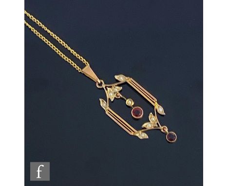 An early 20th Century 9ct garnet and seed pearl open work pendant of rectangular form, length 4cm, suspended from a 9ct trace