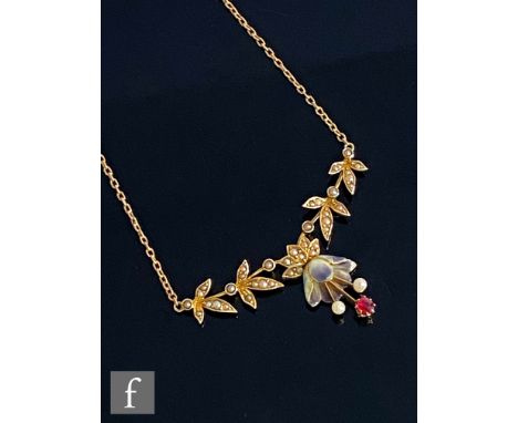 An early 20th Century 15ct seed pearl floral necklet, four panels to a stiff bar above enamel flower head with protruding twi