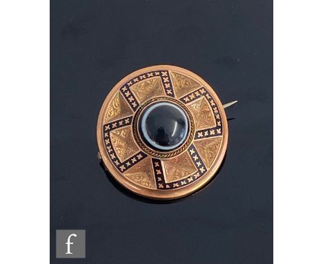 A 19th Century 9ct rose gold circular memorial brooch with central banded agate, black enamel details and foliate engraved gr