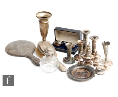 A parcel lot of assorted hallmarked silver and white metal items to include a piano candlestick, condiments, a hand mirror, n